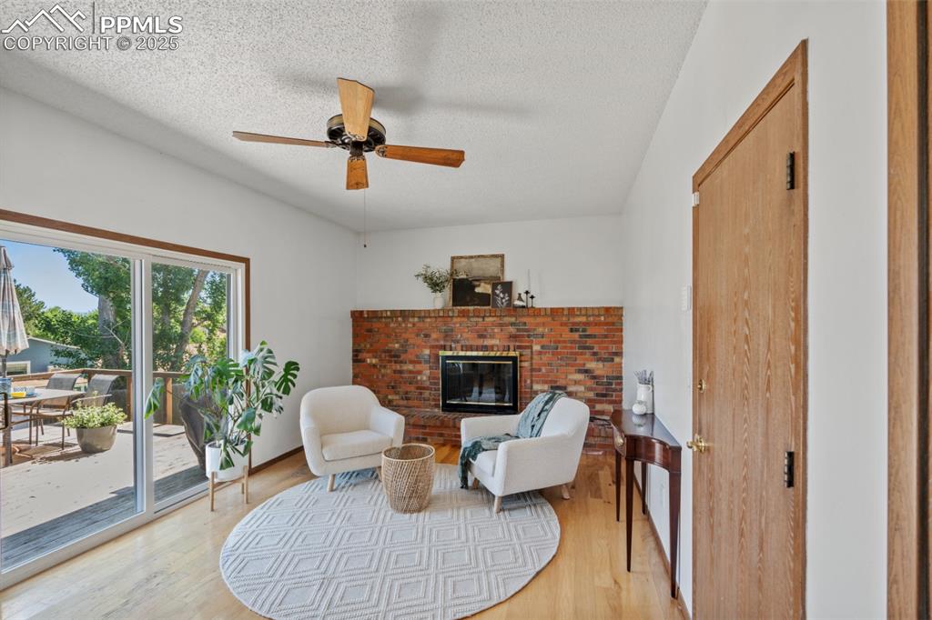 Image 15 of 46: Secondary Living Space with Gas Fireplace, Entrance into Garage and Deck