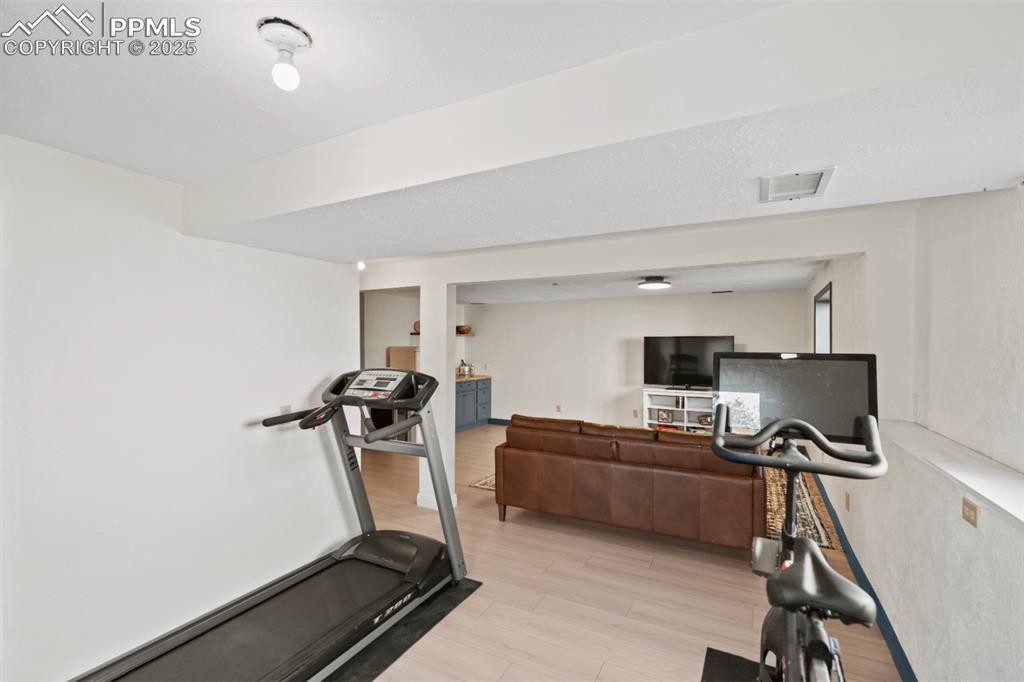 Image 24 of 46: Adjacent Space next to Basement Living Room, currently a converted Gym Spac