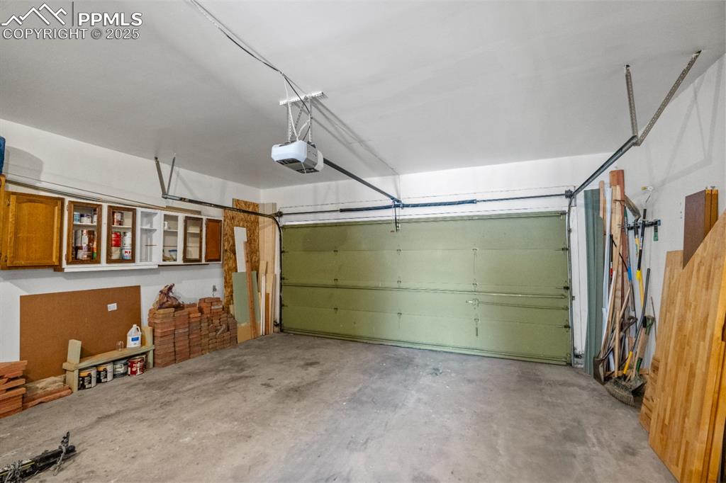 Image 38 of 46: Garage with Built-In Shelving