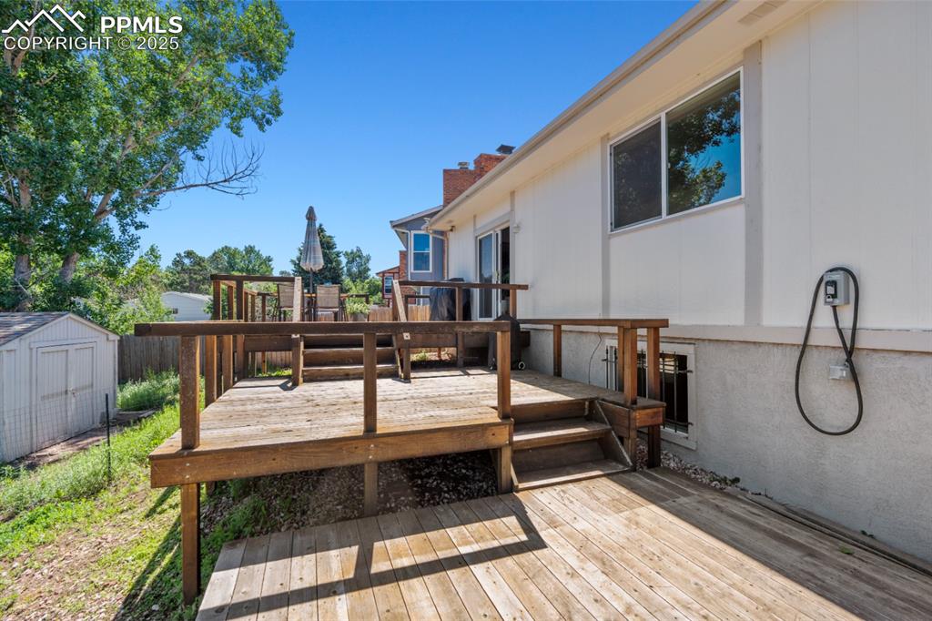 Image 44 of 46: Rear of House, Three-Tiered Deck that can support a hottub.