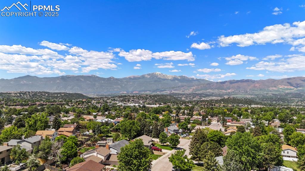 Image 5 of 46: Aerial perspective of suburban area with a mountain backdrop