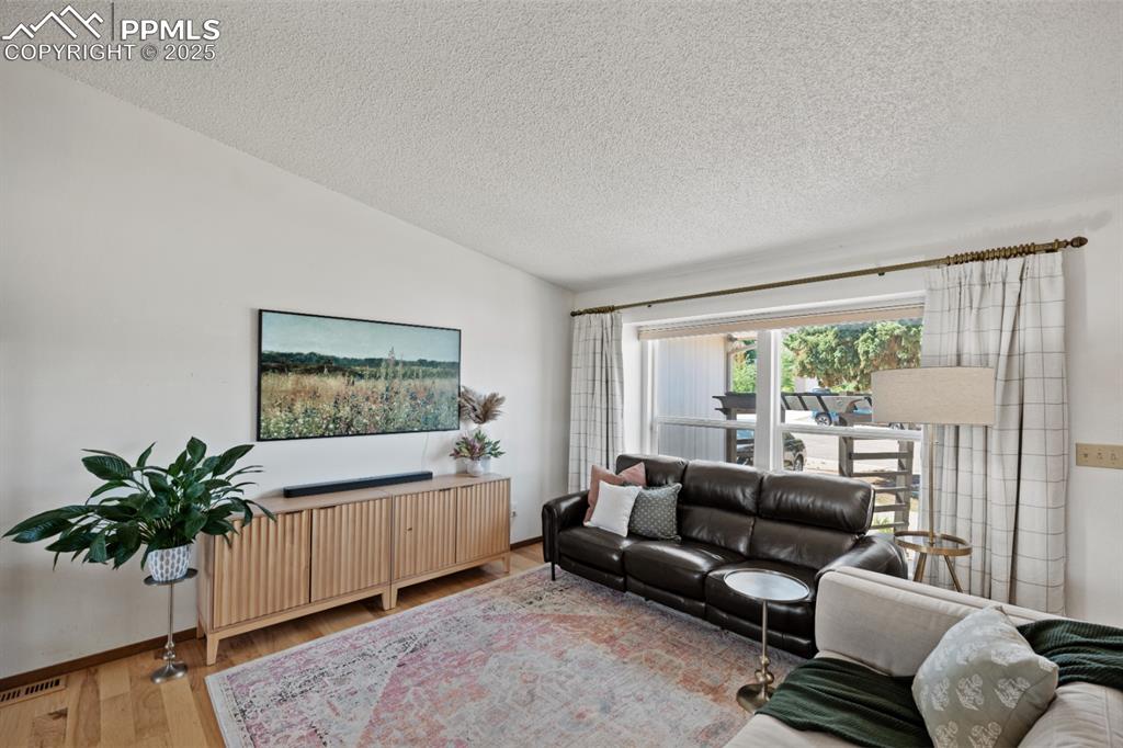 Image 8 of 46: Primary Living Area with Large Bay Windows