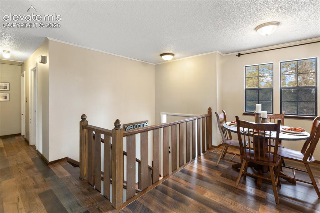 Image 12 of 41: Wood-finish flooring extending throughout, complemented by a light neutral