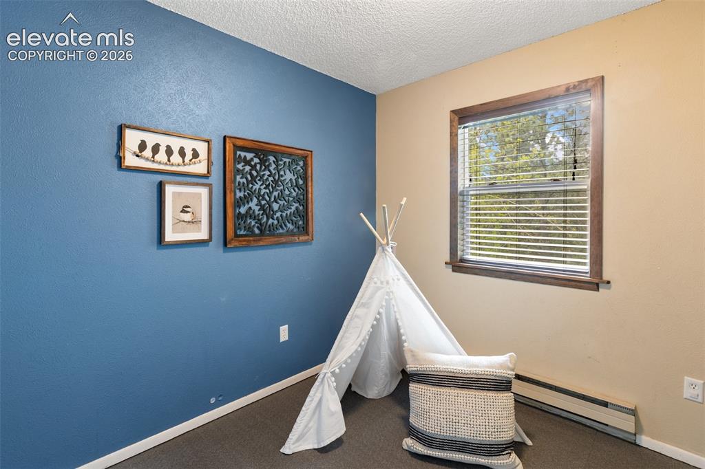 Image 17 of 41: Window featuring wood-finish trim and horizontal blinds