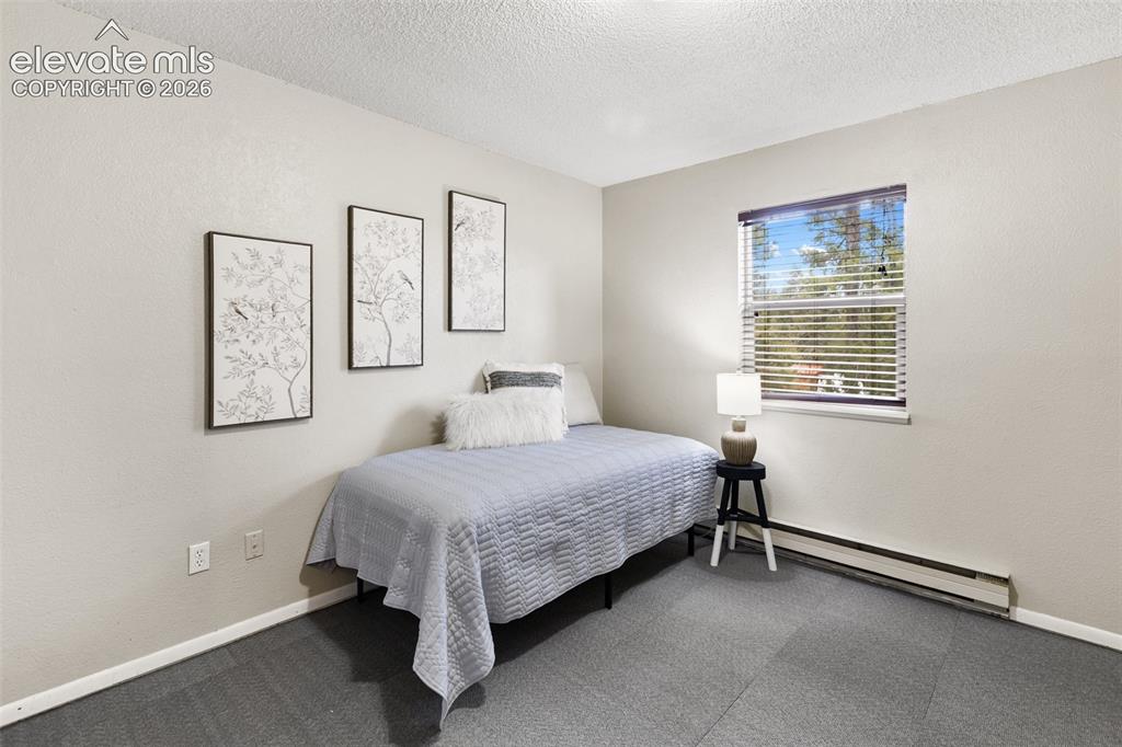 Image 19 of 41: Room featuring light-colored walls and grey square-tile flooring