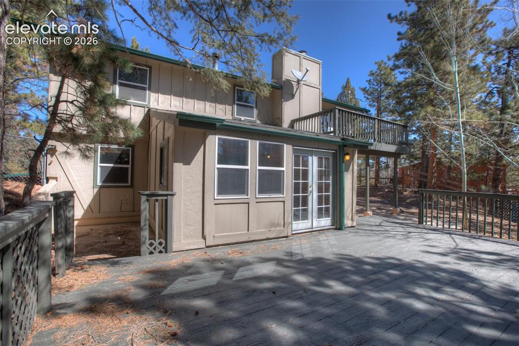 Image 2 of 41: Multi-level deck with wood railing, offering access to the property