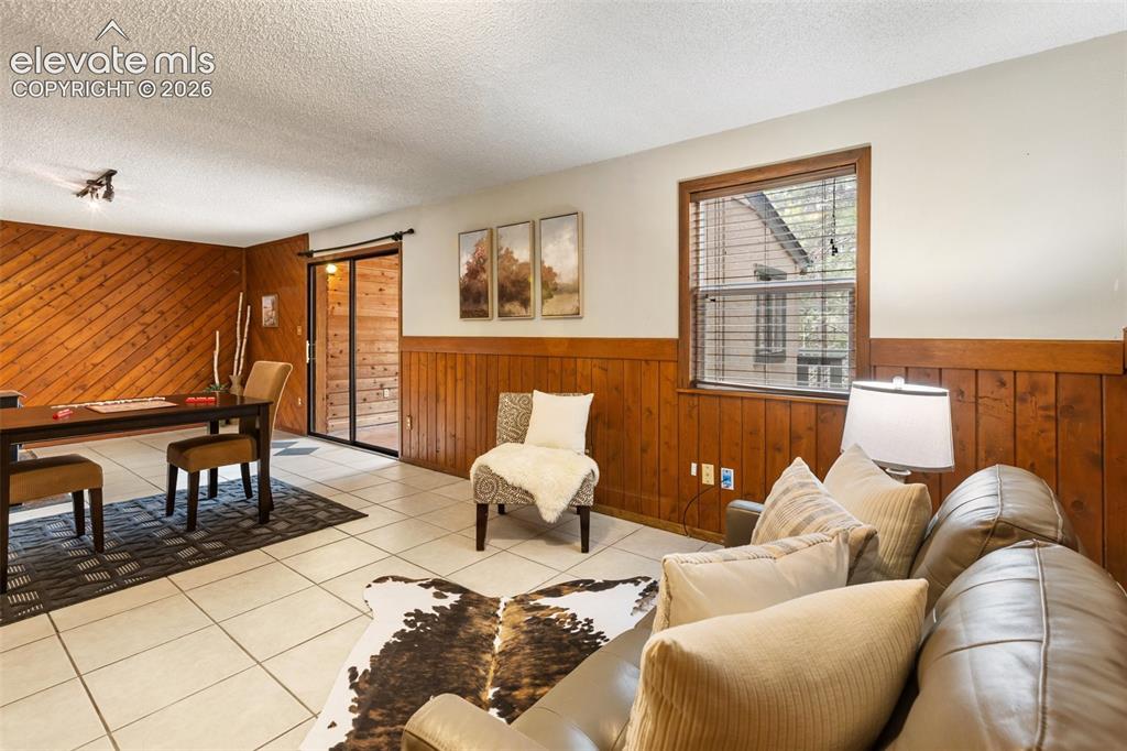 Image 24 of 41: Spacious interior featuring a combination of wood paneling and light-toned