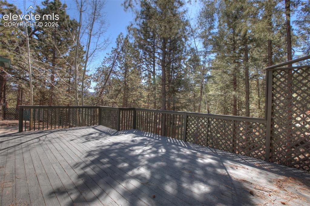 Image 39 of 41: Expansive outdoor deck featuring wood-finish flooring and a wood railing wi