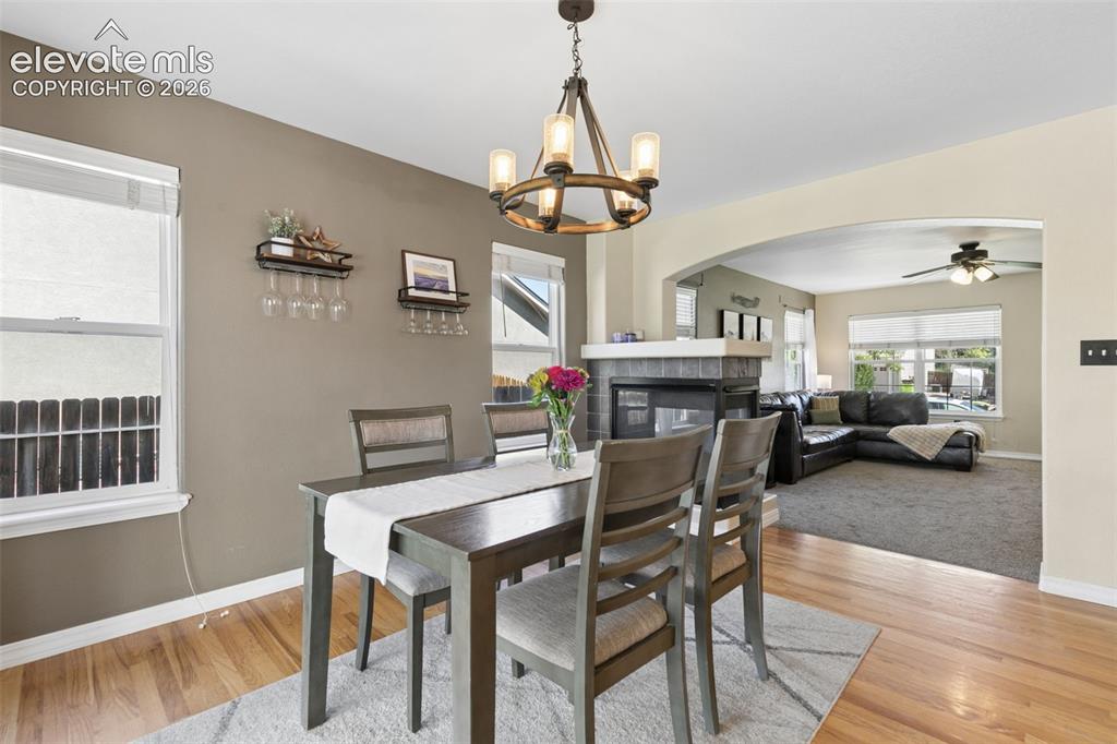 Image 11 of 48: Wood-finish flooring, recessed windows with blinds, a multi-light chandelie