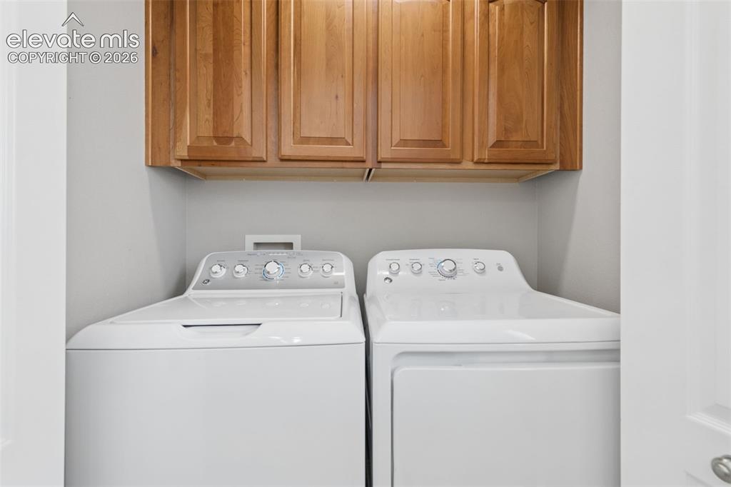Image 18 of 48: Upper cabinetry with wood-finish doors