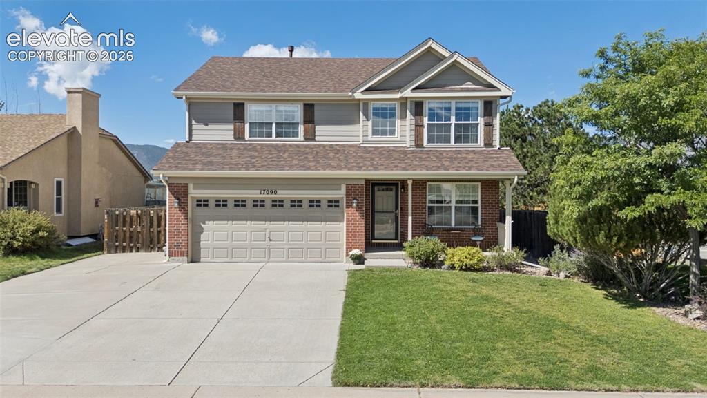 Image 2 of 48: Two-story residence featuring a brick facade, attached two-car garage, and 