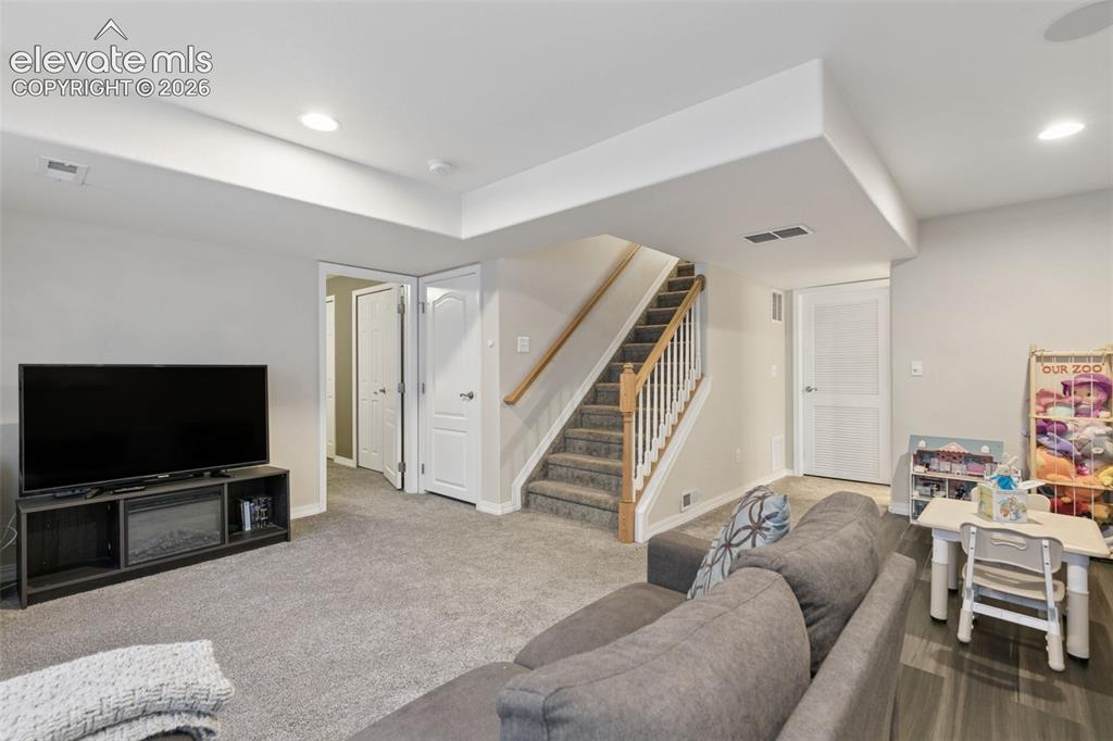 Image 33 of 48: Spacious room featuring neutral carpeting, recessed lighting, white interio