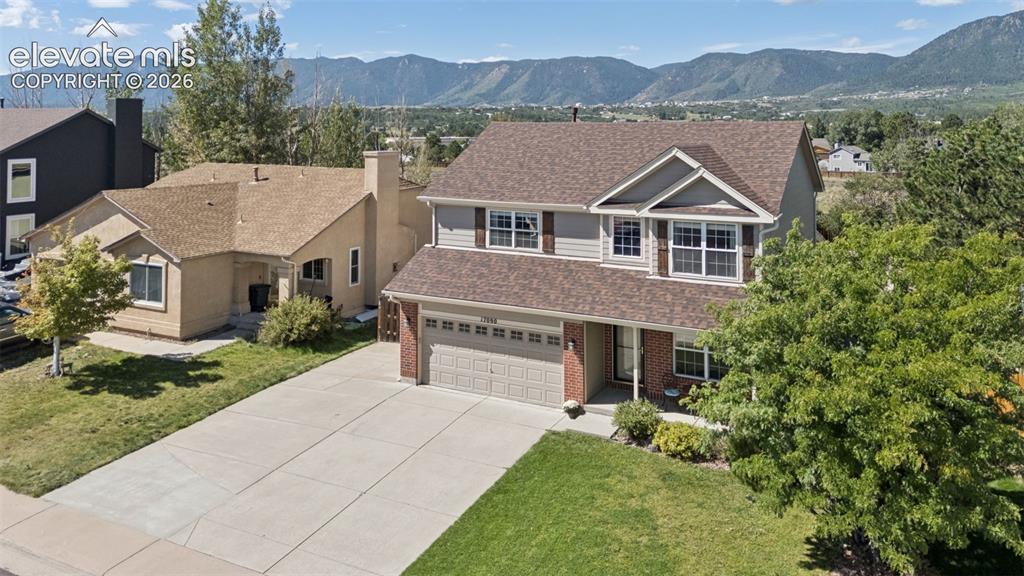 Image 44 of 48: Two-story residence featuring a two-car garage, concrete driveway, front la
