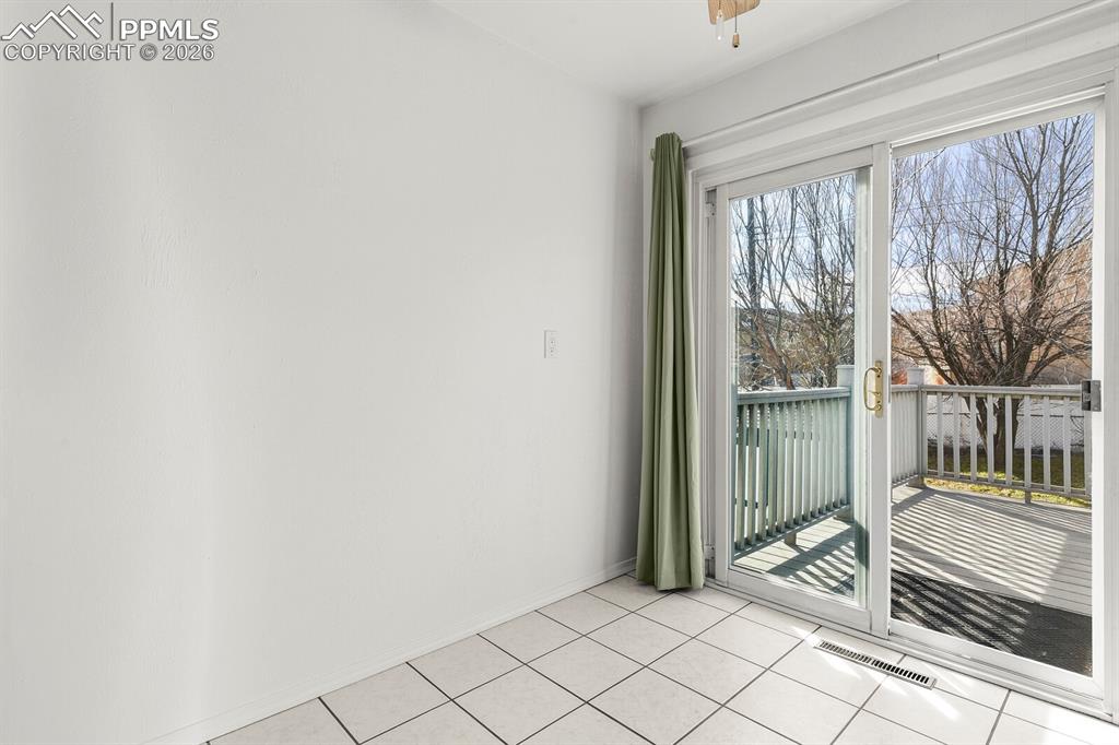 Image 10 of 49: Empty room featuring light tile patterned floors