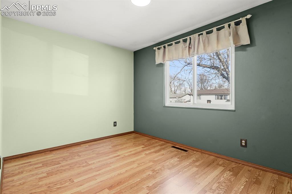 Image 15 of 49: Empty room with light wood finished floors and baseboards