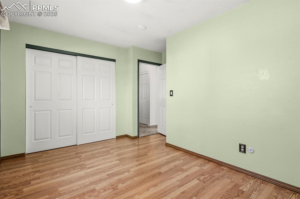Image 17 of 49: Unfurnished bedroom featuring wood finished floors and a closet