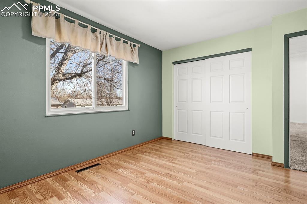 Image 18 of 49: Unfurnished bedroom featuring a closet and light wood-style flooring