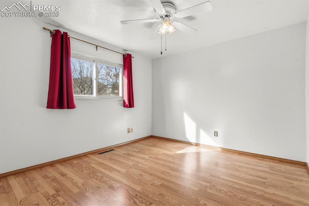 Image 20 of 49: Spare room featuring light wood-type flooring and ceiling fan