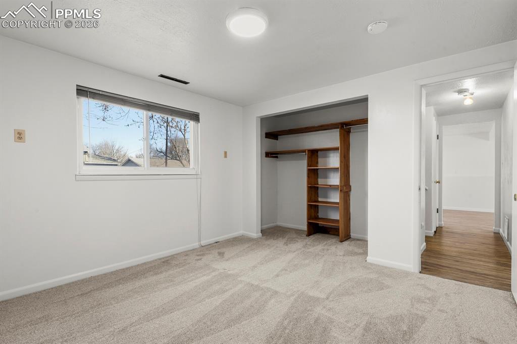 Image 24 of 49: Unfurnished bedroom with a closet and light carpet