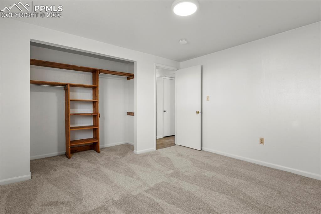 Image 25 of 49: Unfurnished bedroom with light carpet and a closet
