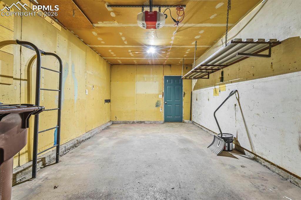 Image 37 of 49: Garage with a garage door opener