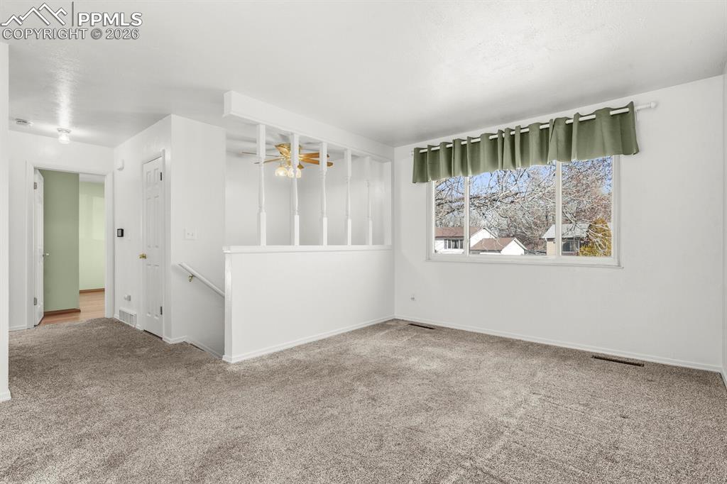 Image 4 of 49: Spare room with carpet floors and a chandelier