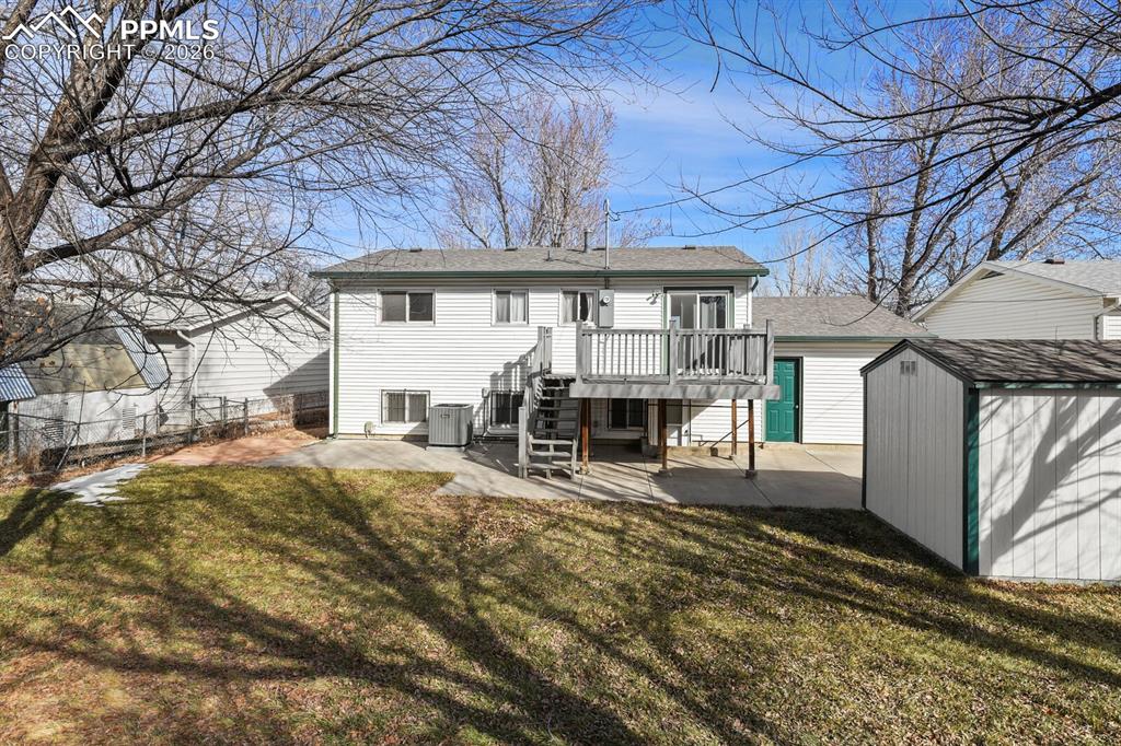 Image 40 of 49: Rear view of property with a patio area, a storage shed, stairs, a wooden d