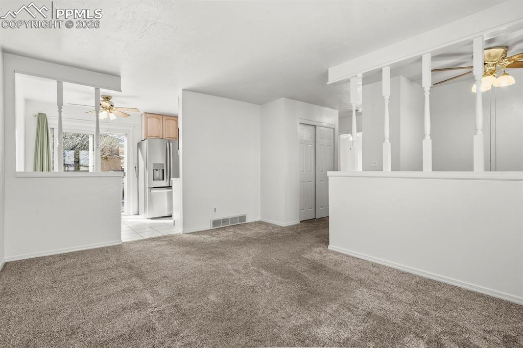 Image 5 of 49: Living room leading into the Kitchen , Knock and hallway to the bedrooms an