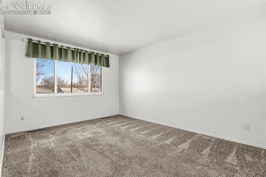 Image 7 of 49: Carpeted empty room featuring baseboards
