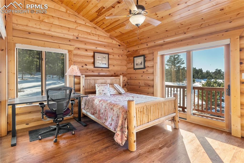 Image 21 of 46: Another view of the secondary bedroom with walk-out to the deck and views f