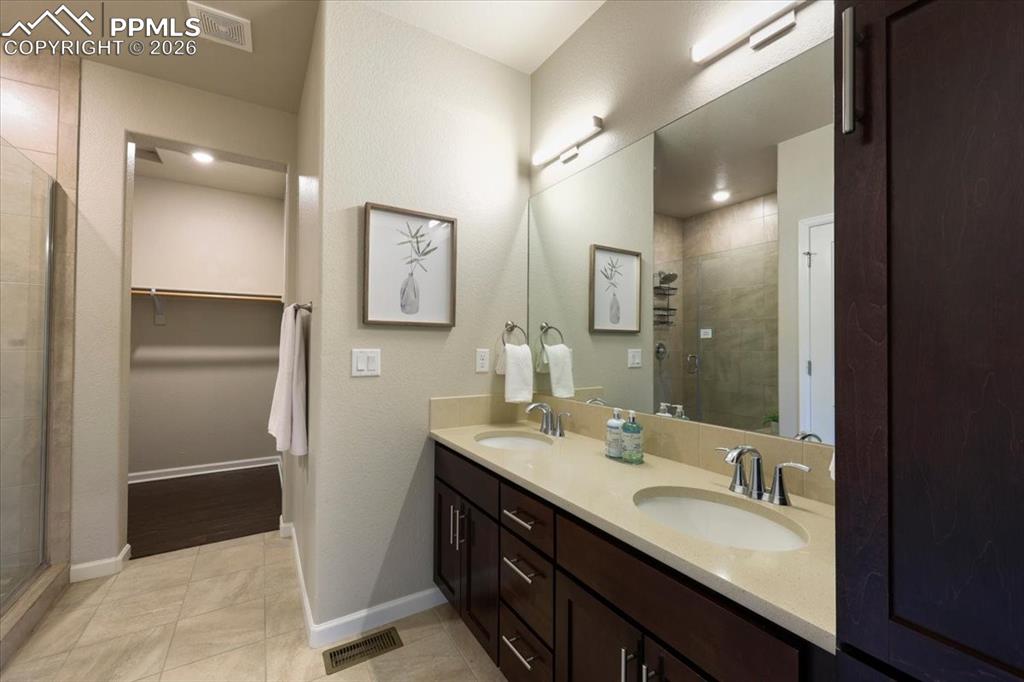 Image 10 of 19: Full bathroom featuring visible vents, a sink, and a stall shower