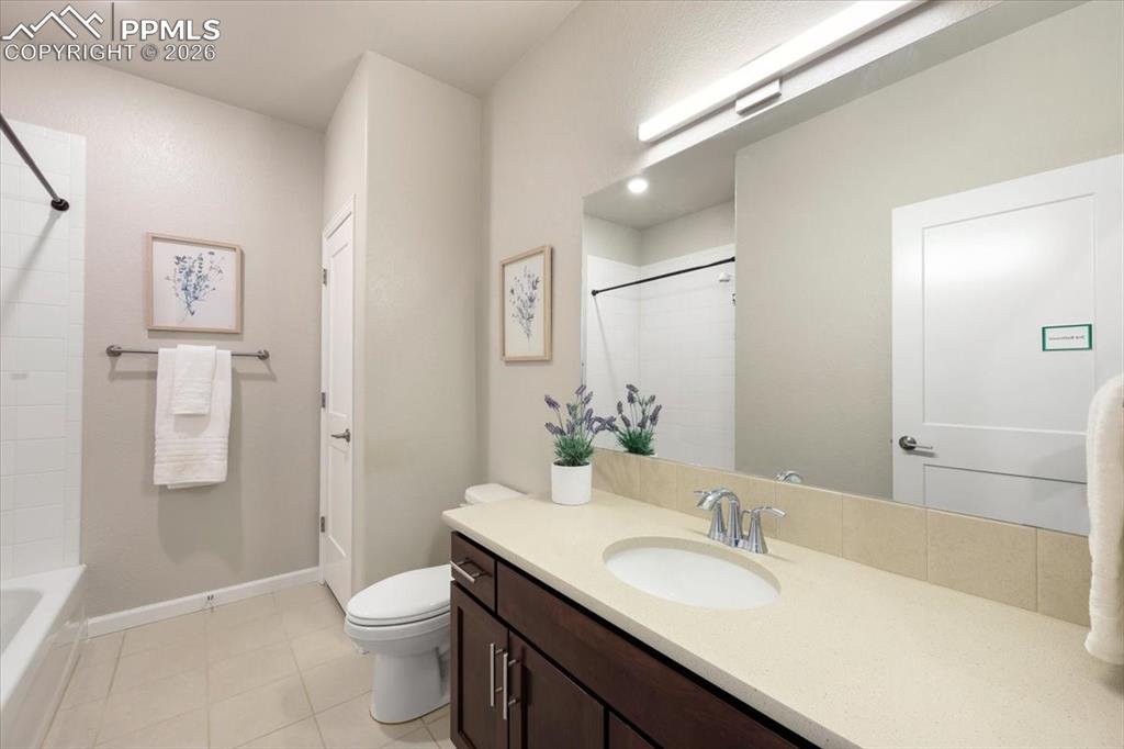 Image 16 of 19: Full bath featuring baseboards, shower / washtub combination, toilet, vanit