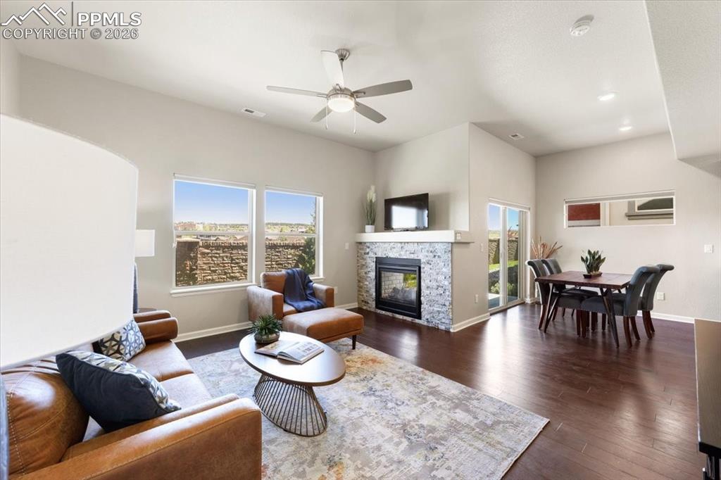 Image 5 of 19: Living area featuring a wealth of natural light, a fireplace, and baseboard
