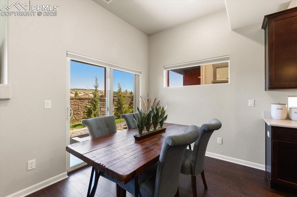 Image 8 of 19: Dining room featuring baseboards and dark wood-style floors