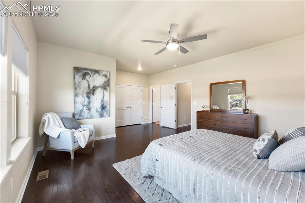 Image 9 of 19: Bedroom with visible vents, baseboards, a ceiling fan, and wood finished fl