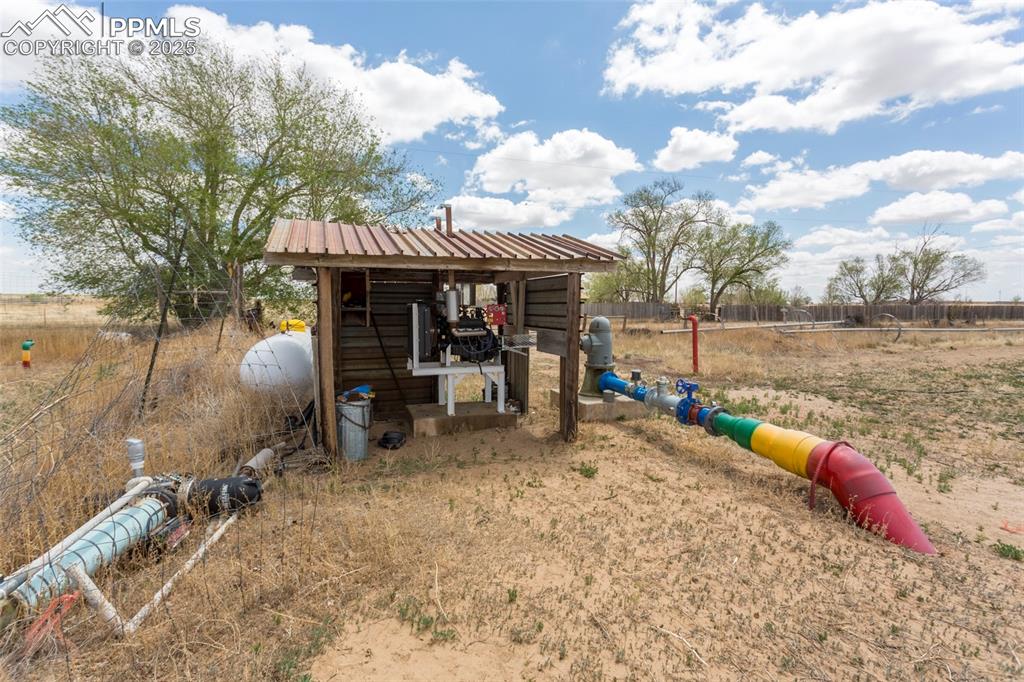 Image 17 of 26: View of outbuilding featuring fence and a rural view