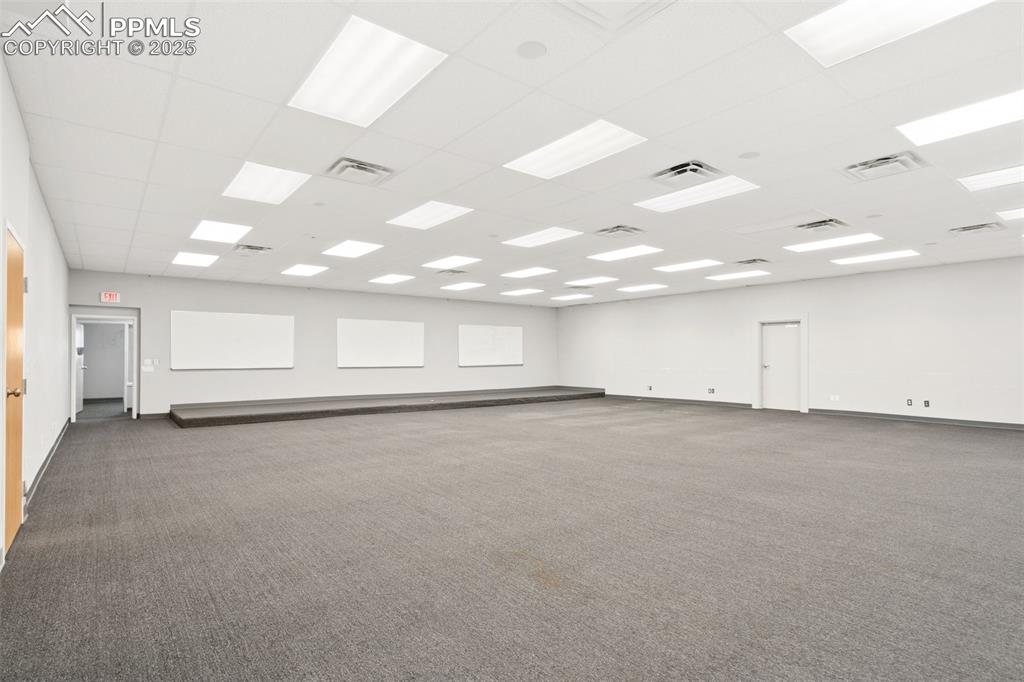 Image 24 of 26: Empty room with carpet and baseboards