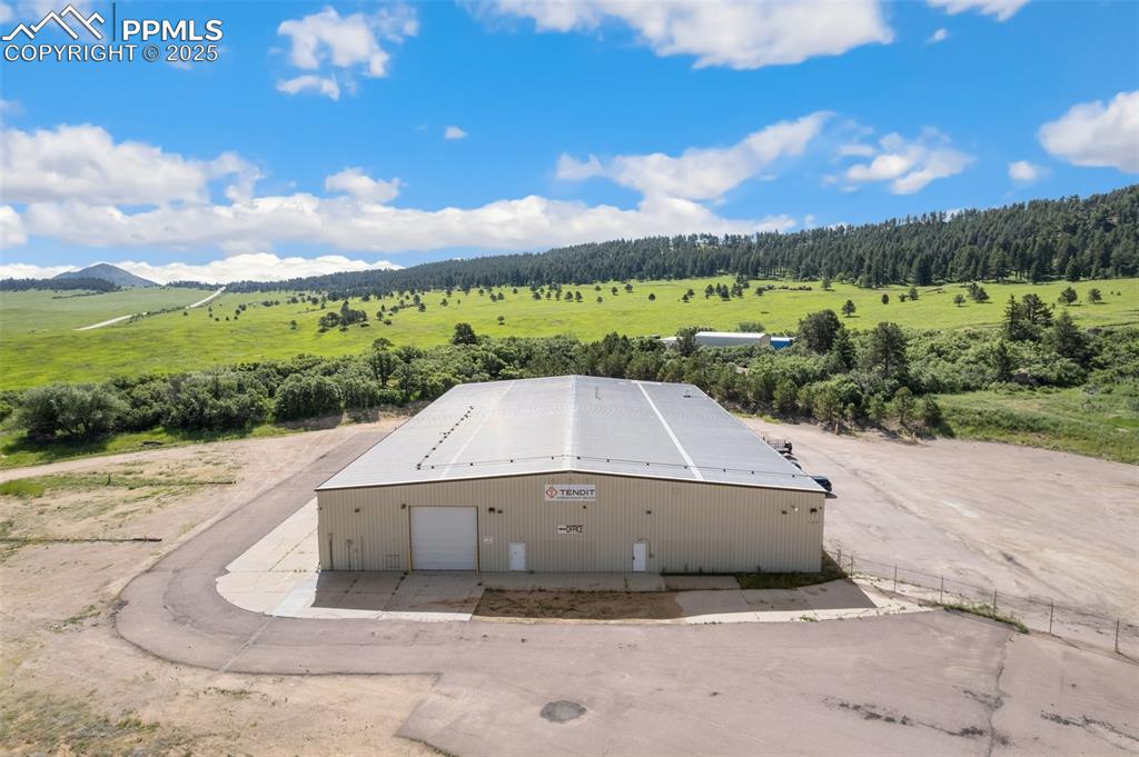 Image 7 of 26: Aerial view of property and surrounding area featuring a mountainous backgr