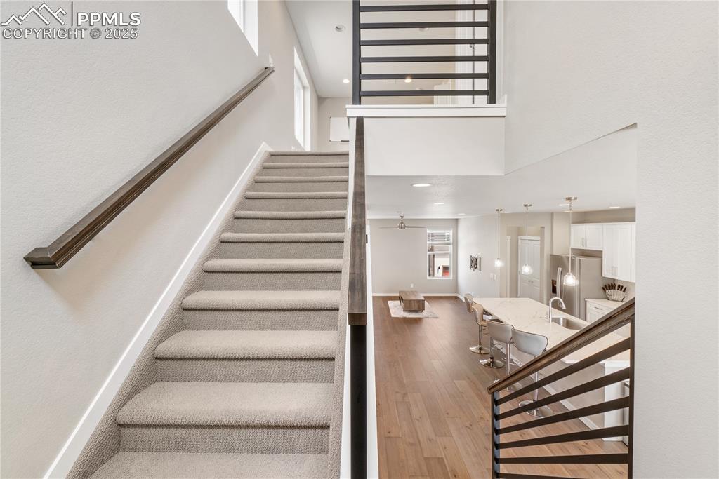 Image 23 of 42: Stairs to upper and main level