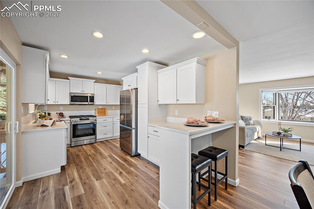 Image 11 of 45: Fully updated kitchen with quartz countertops, new white cabinetry, SS, gas