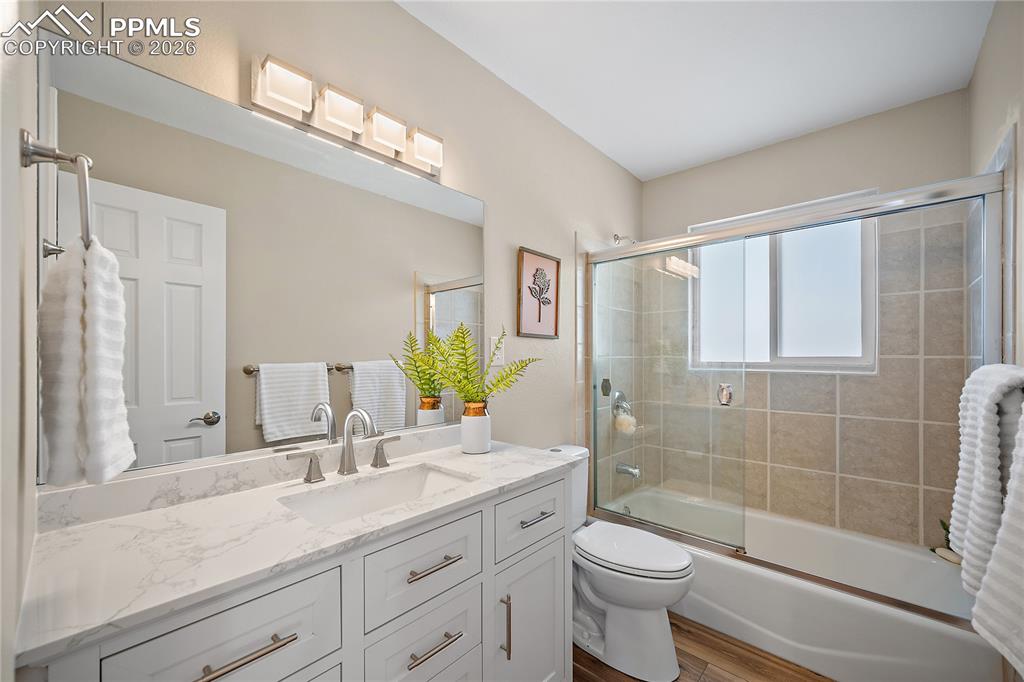 Image 17 of 45: Upstairs full bath, large updated vanity, new flooring, lighting and fresh 