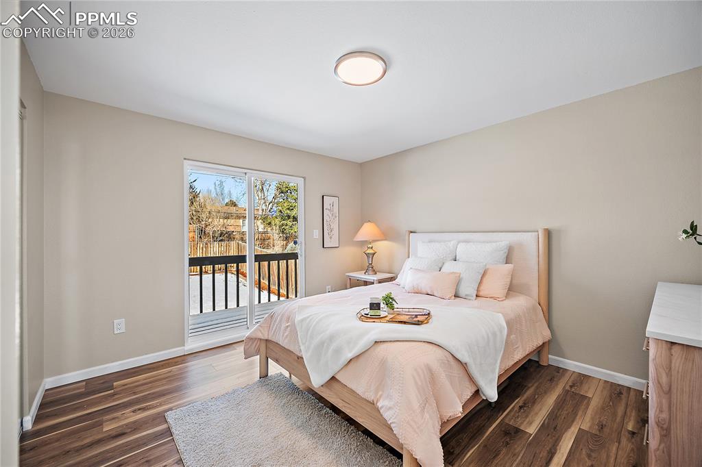 Image 18 of 45: Primary bedroom with walk out to private deck. New flooring paint and light
