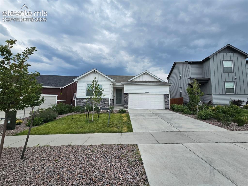 Caption: Contemporary facade featuring white siding and stone accents