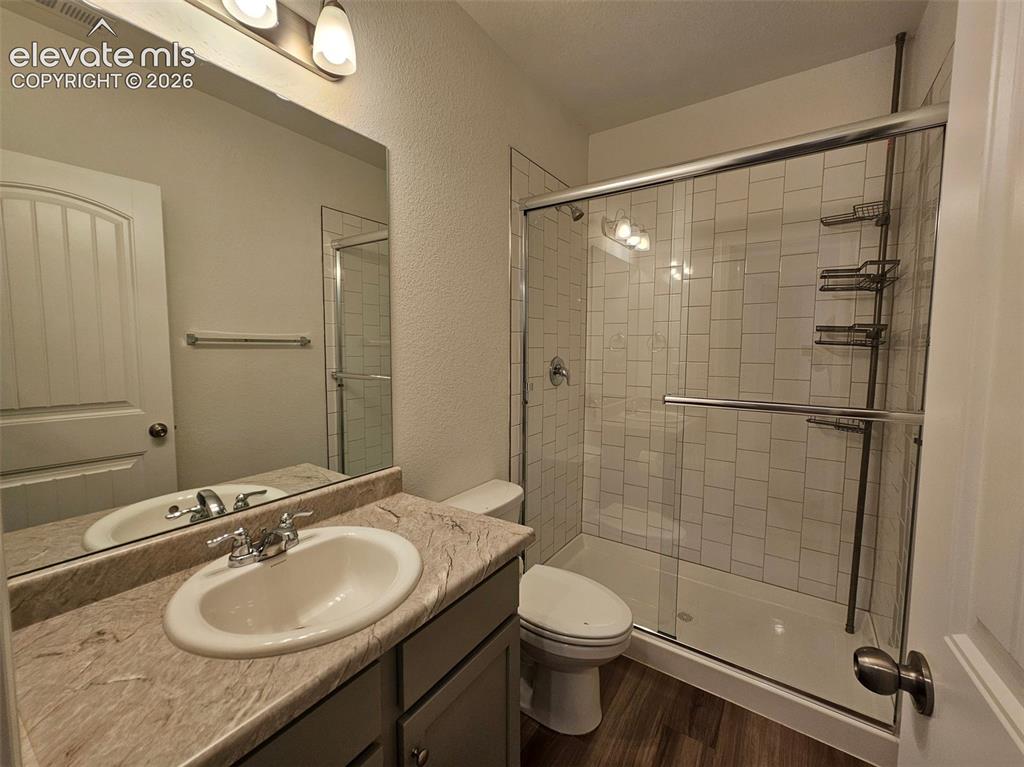 Image 20 of 25: Vanity with integrated sink, stone-finish countertop, and built-in mirror