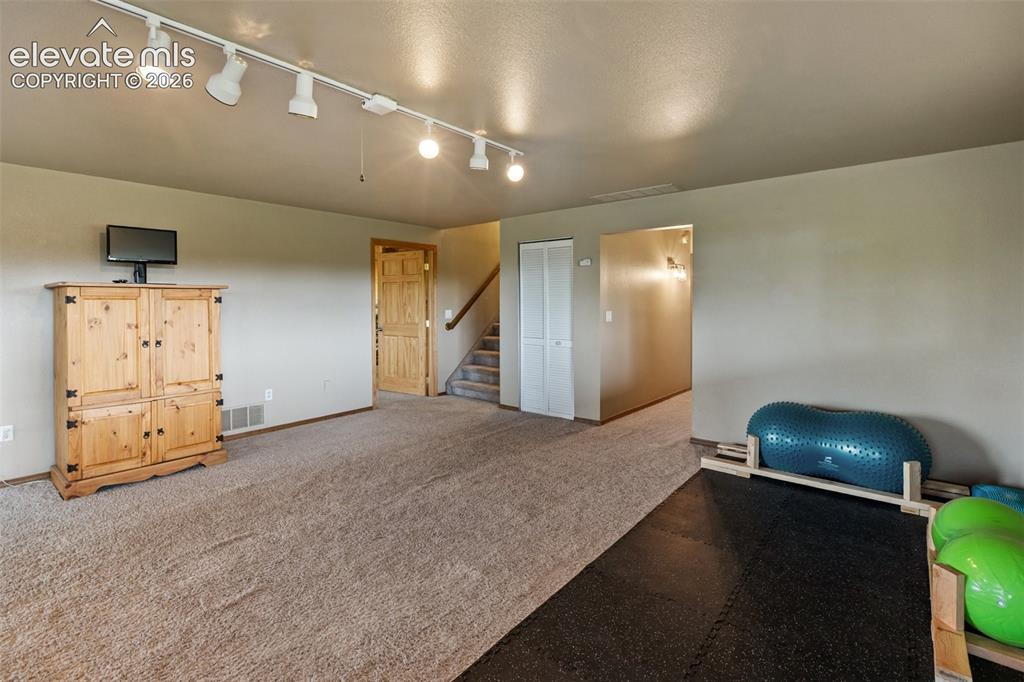 Image 46 of 50: Lower level family room with walkout to concrete patio.