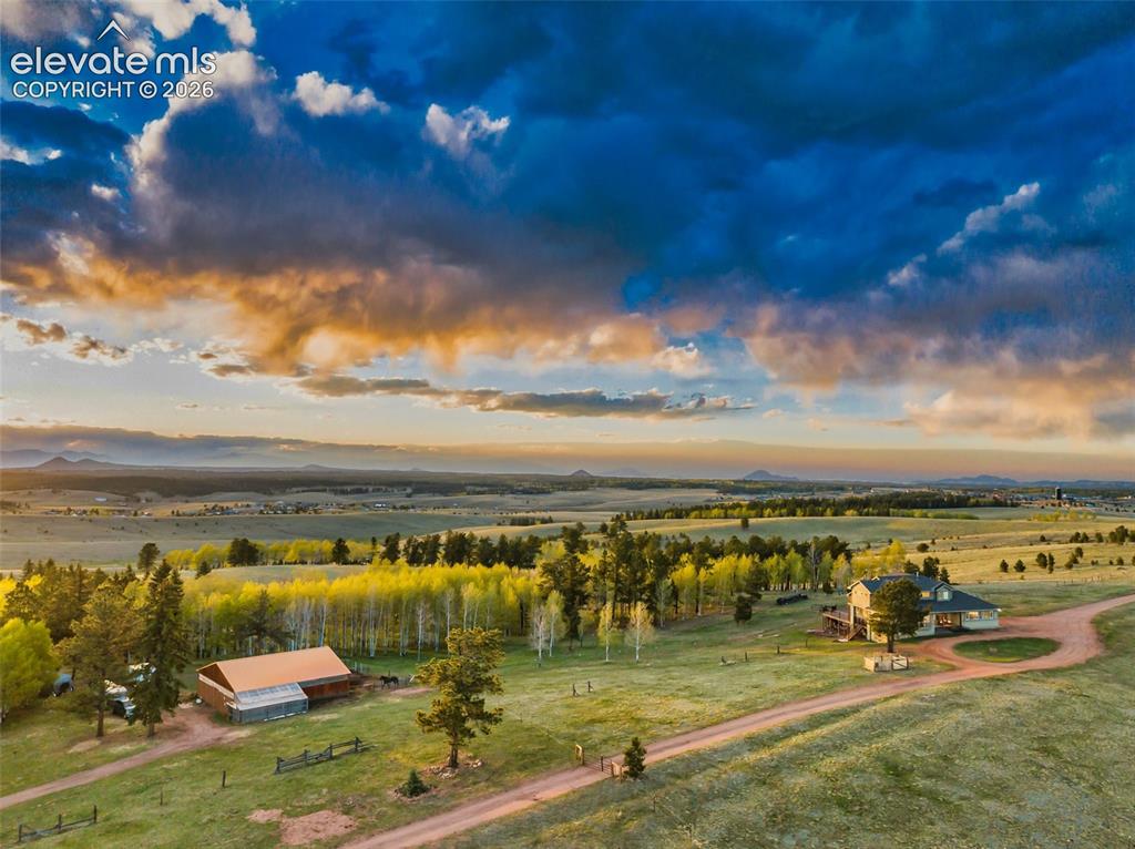 Image 6 of 50: Expansive rural property featuring a primary residence, a barn structure, m