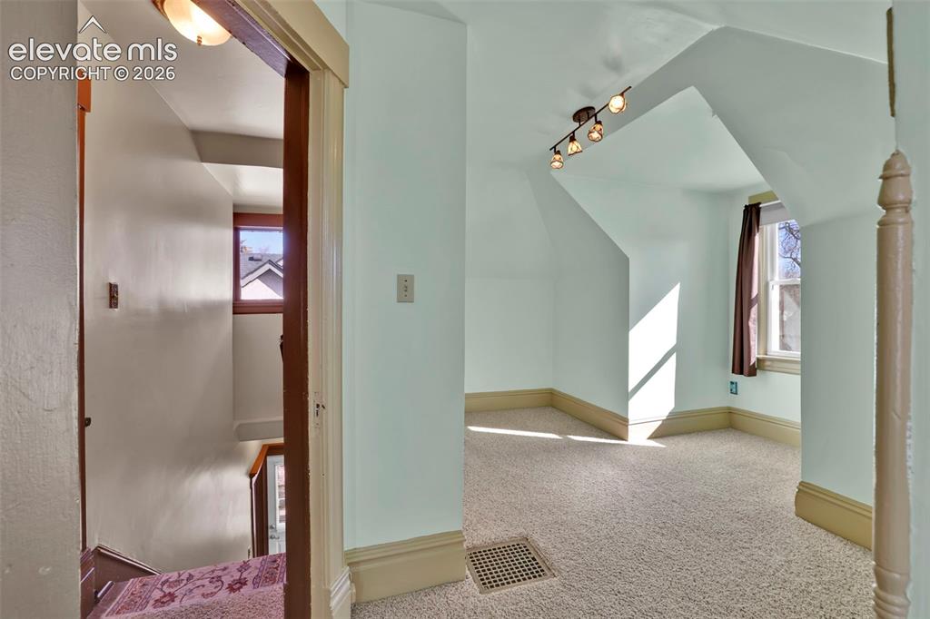 Image 33 of 48: stairs and secondary upstairs bedroom