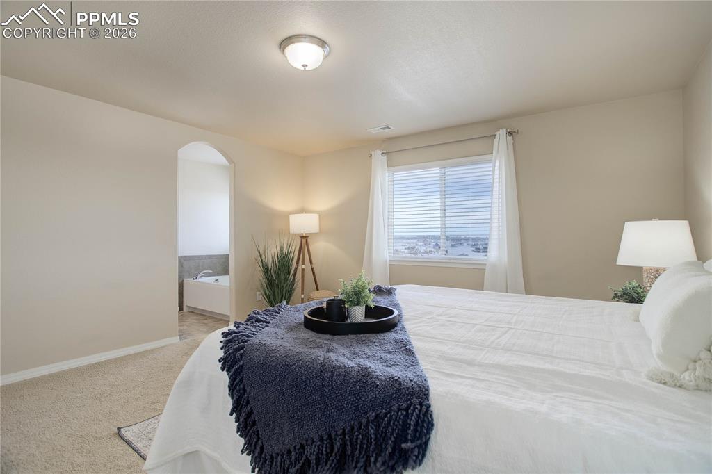 Image 14 of 23: En-suite primary bath & walk-in closet