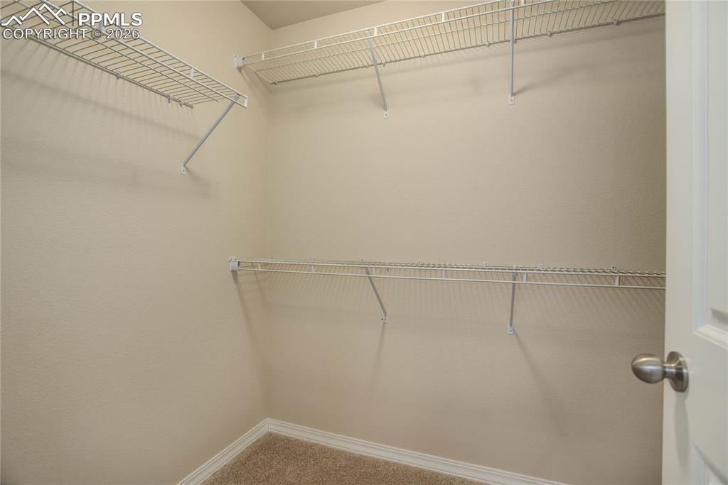Image 17 of 23: Primary suite walk-in closet