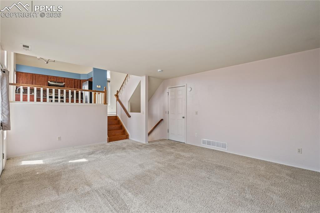 Image 15 of 43: Warm and inviting dining area with chandelier and hardwood flooring